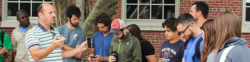 Professor leading a class on quad.